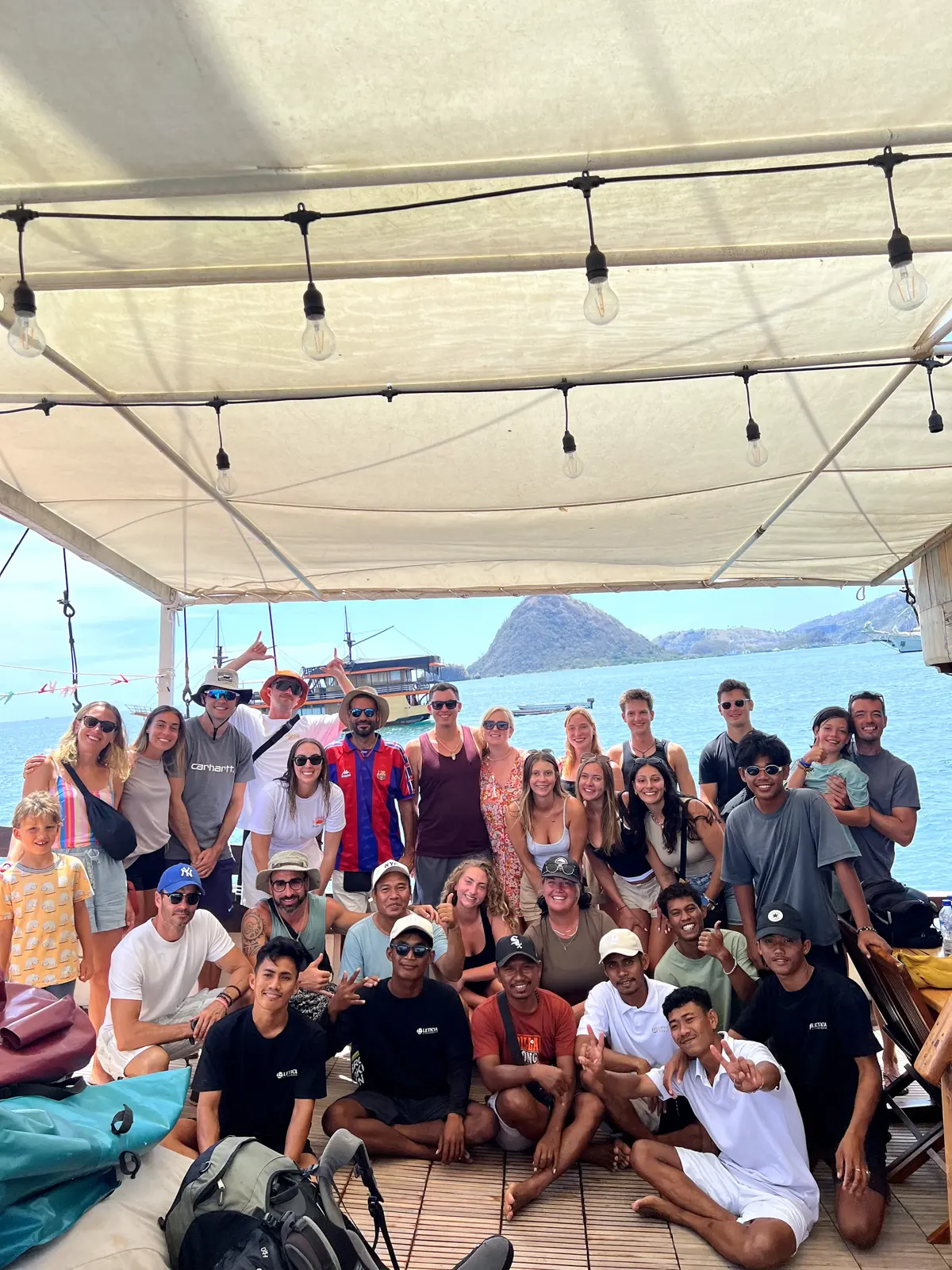 A large open trip group on the boat deck