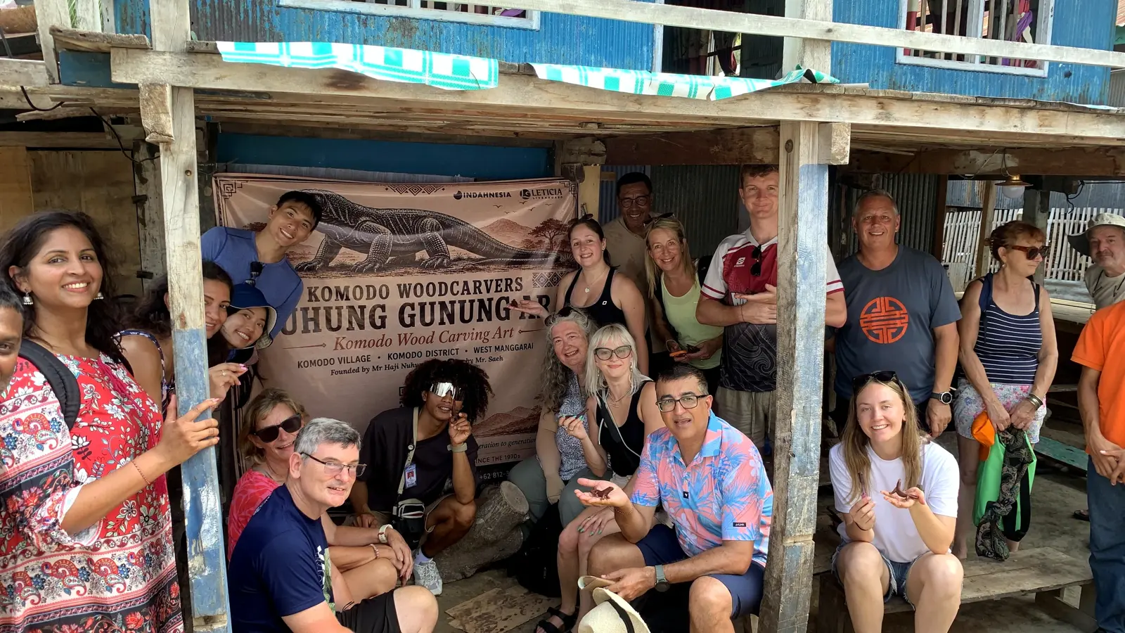 A group of guests at a Komodo woodcarving village