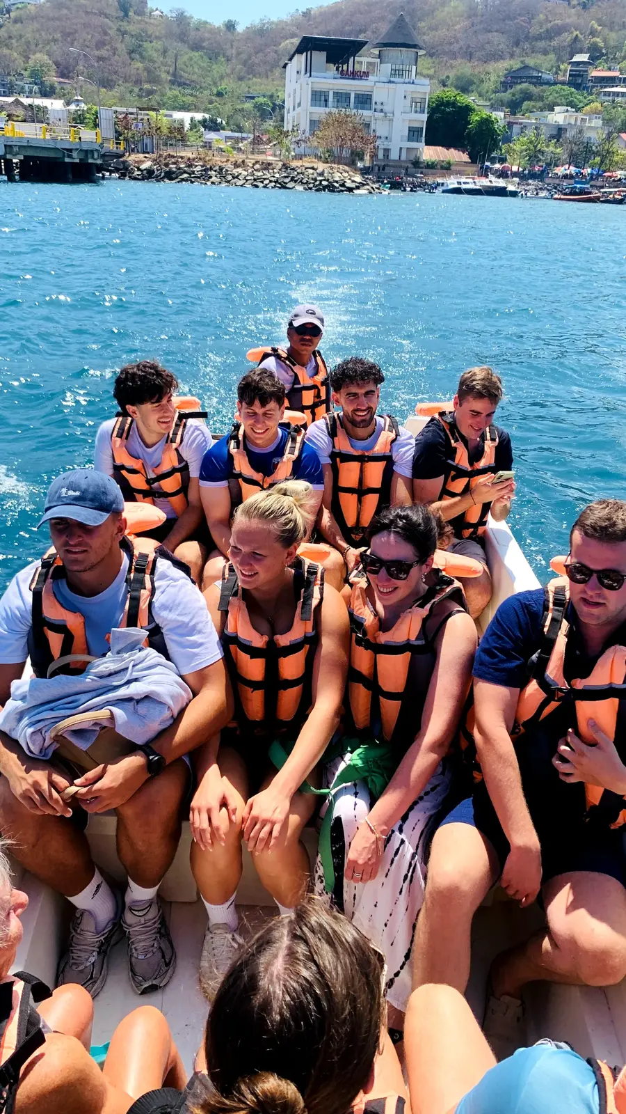 A group of guests in life jackets on a speedboat