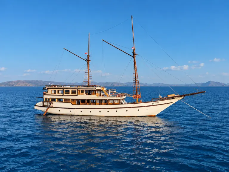 Alfathran 3, a long wooden phinisi with two masts in Komodo National Park waters