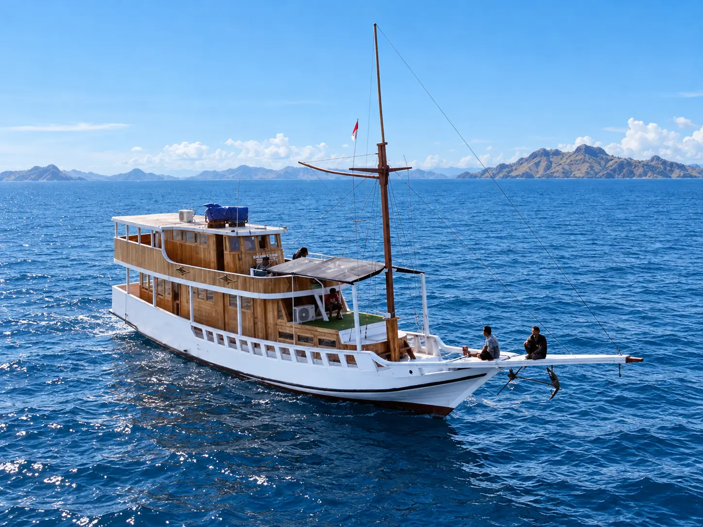 Diara La Oceano, a two-deck wooden boat with a white hull in Komodo National Park waters