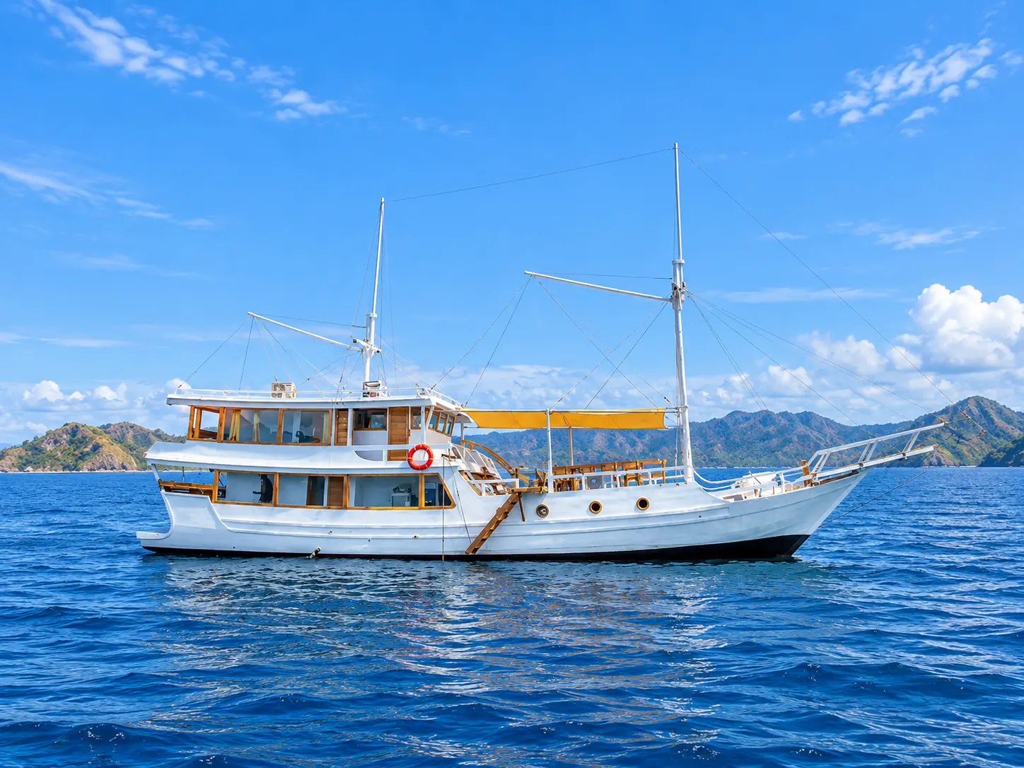 Gajah Putih, a white two-masted phinisi in Komodo National Park waters