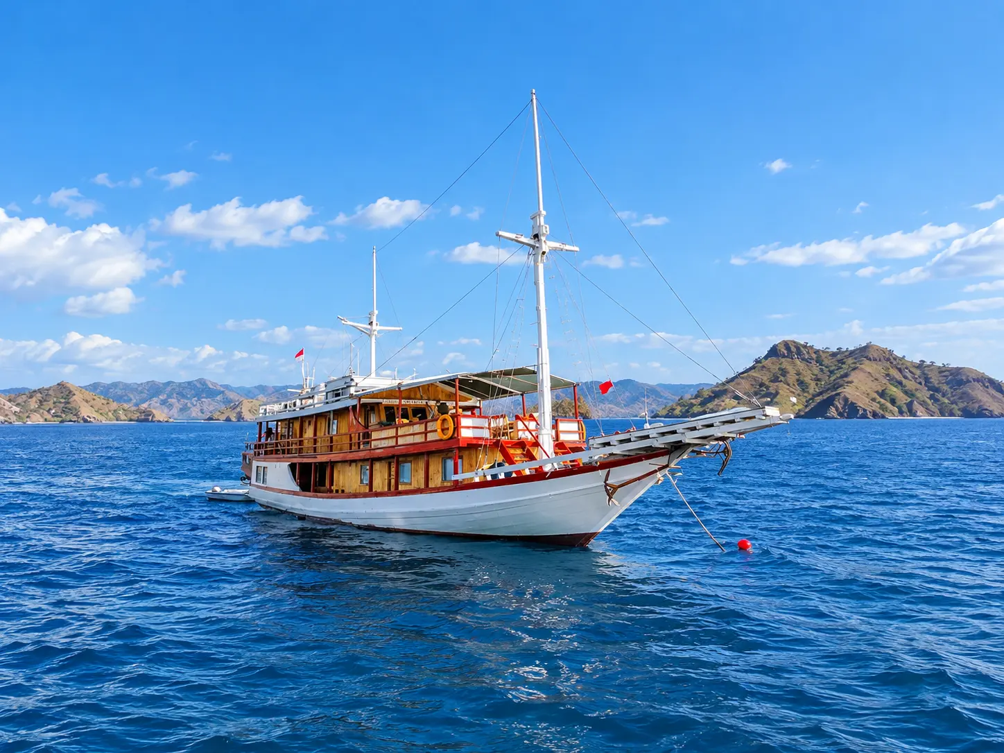 Hatira Hela, a white-hulled wooden phinisi in Komodo National Park waters