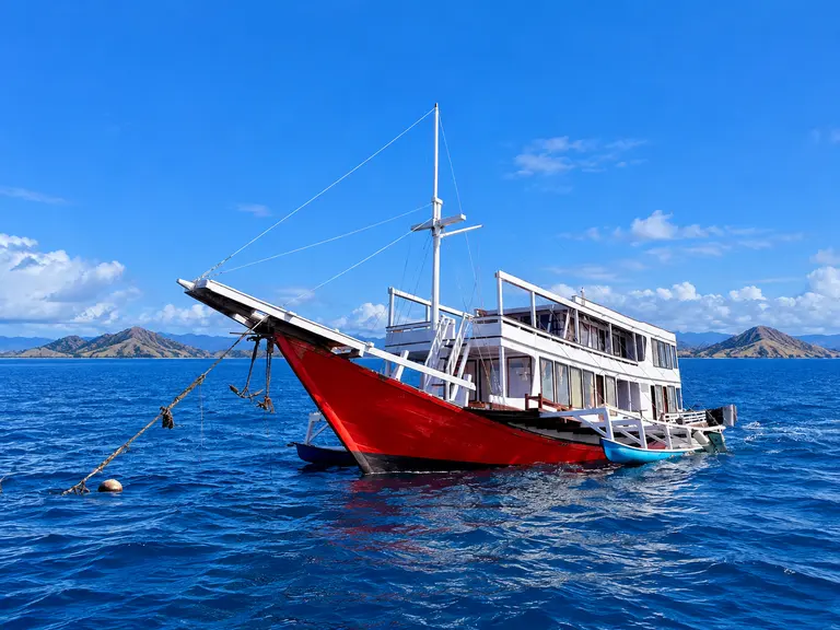 King Cirox 2, a wooden boat with a red hull in Komodo National Park waters