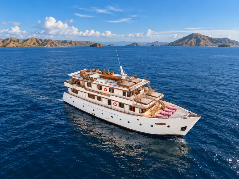 Le Costa, a multi-deck white-hulled boat seen from above in Komodo National Park waters