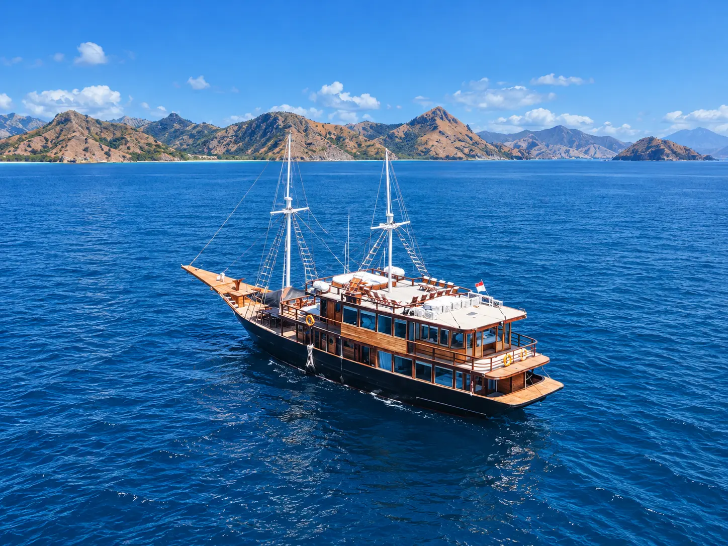 Marea, a brown-hulled wooden phinisi in Komodo National Park waters