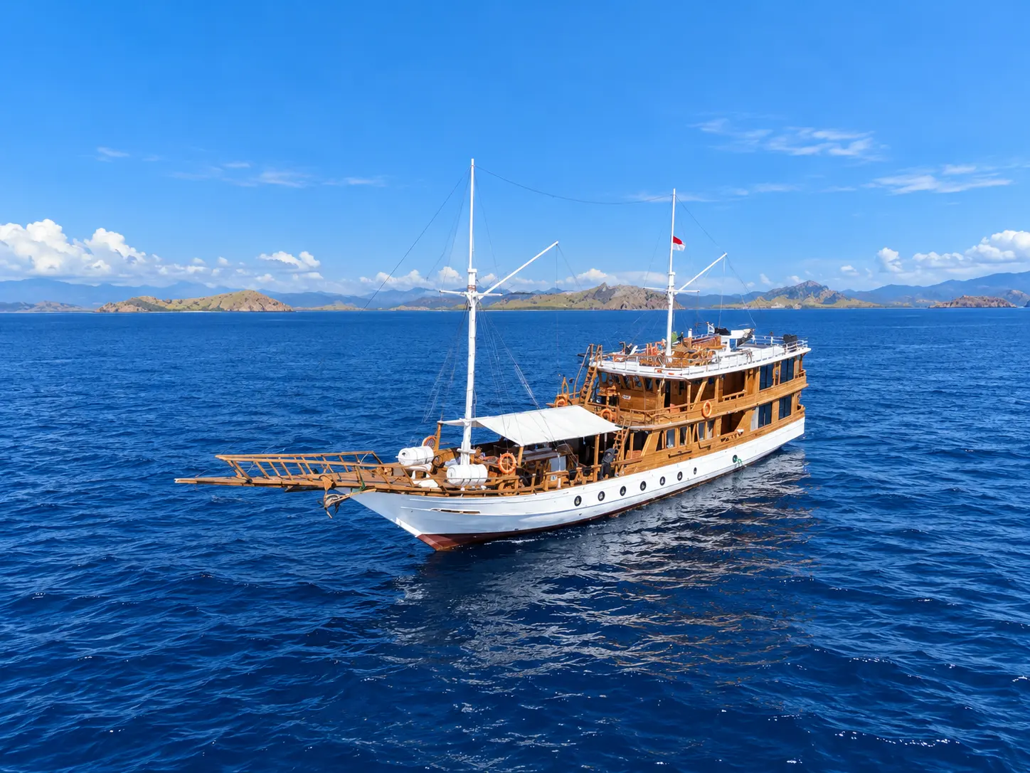 Medina Mecca, a white-hulled wooden phinisi in Komodo National Park waters