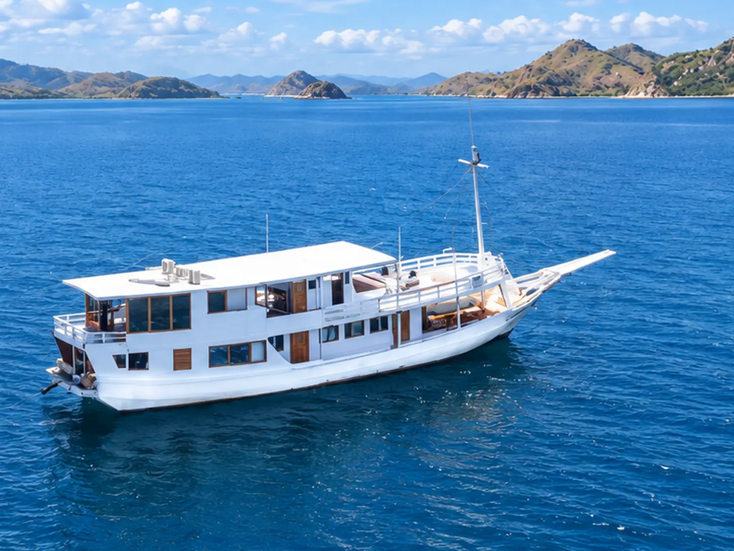 Nusantara Karya, a two-deck white phinisi in Komodo National Park waters