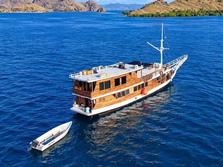 Segara, a two-deck wooden boat with a white hull in Komodo National Park waters